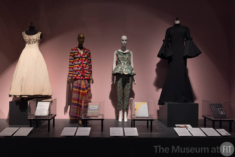 Christian Dior, ball gown, fall 1957; La Cuisine Cousu-Main (Tailor-Made Cuisine) cookbook, 1972, Lent by Michelle Tolini Finamore; Missoni, knit plaid jacket and skirt, 1971; The Missoni Family Cookbook, 2018, Lent by Melissa Marra-Alvarez; Phillip Lim 3.1, green cotton and gold sequins ensemble, pre-fall 2021; More Than Our Bellies, 2018; Lent by Phillip Lim; Christian Siriano, black gown with flared sleeves, 2021, Lent by Christian Siriano; Angie Mar, Butcher + Beast: Mastering the Art of Meat: A Cookbook, 2019.