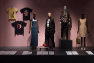 Food & Fashion exhibition installation view of three wall-mounted t-shirts, four dressed manneq…