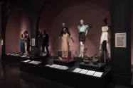 Food & Fashion exhibition installation view of platform with wall mounted t-shirts, eight dress…