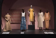 Food & Fashion exhibition installation view of five dressed mannequins and a wall mounted texti…