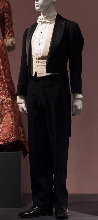  Black evening suit, notched collar dresed with white vest, bowtie and shirt