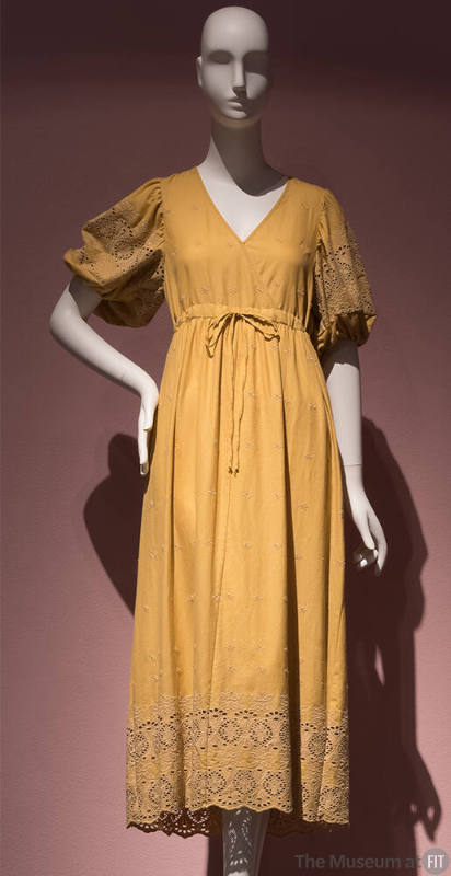 Yellow cotton dress with V neck bodice, floral eyelet embroidered puff sleeves and hem border, …