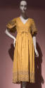 Yellow cotton dress with V neck bodice, floral eyelet embroidered puff sleeves and hem border, …