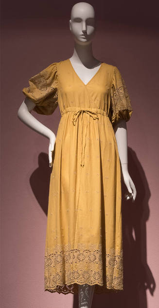 Yellow cotton dress with V neck bodice, floral eyelet embroidered puff sleeves and hem border, …
