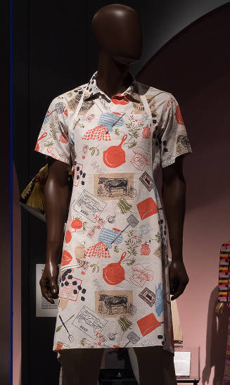 Man’s white apron and matching short sleeve shirt with orange, blue, beige, green and black pri…