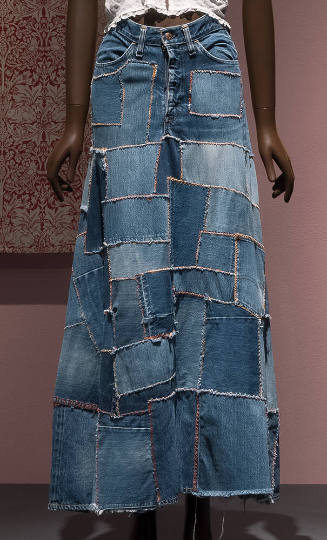 Blue denim patchwork flared maxi skirt embroidered with red and orange cross-stitch