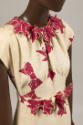 Ivory evening dress, printed with red bows and matching belt