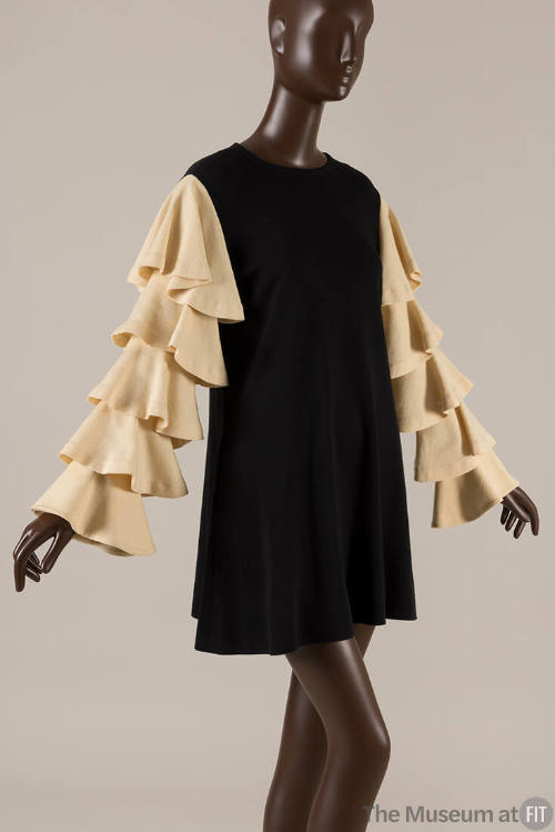 Black minidress with long ivory ruffled sleeves 