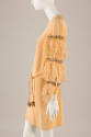 Side view of pale orange mini dress with long feather sleeve with bands of rhinestones and tie …