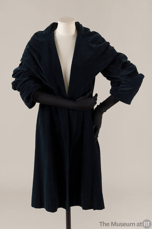 Dark blue velvet wrap coat with high stand shawl collar, matching gloves

