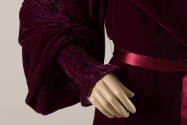 Detail of dark red velvet robe pintucked sleeve and silk ribbon waist tie