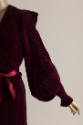 Detail of dark red velvet robe long pintucked sleeve, wide lapel and silk ribbon waist tie