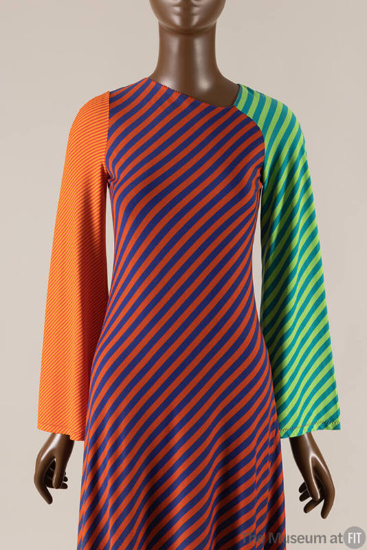 Long sleeve dress with striped color blocked sections of green and blue right arm, yellow and o…