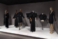 Alternate view of eight mannequins in black garments in the Fundamental Forms section of the St…