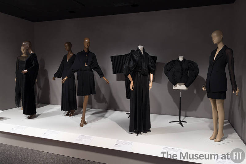 From left to right: dress by Madame Grès, 1978 (86.69.11); dress by Yves Saint Laurent, c.1968 (2022.65.15); dress by Ossie Clark, c.1970 (94.111.1); dress by Ann Demeulemeester, fall 2001 (2002.17.1); man’s robe, c.1925 (90.190.15); evening coat by Vionnet, 1938 (P86.31.3); jacket, c.1895 (91.20.3); suit by Fendi, c.1993 (2014.21.2).