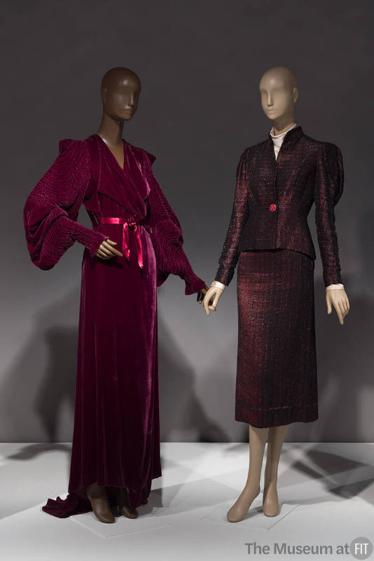 A 1930s dressing gown (left, 2011.25.1) and a 1935 suit by Schiaparelli (87.70.2) in the Opening Statements section of the exhibition.