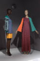 Statement Sleeves exhibition installation view of two mannequins in multicolor dresses in the A…