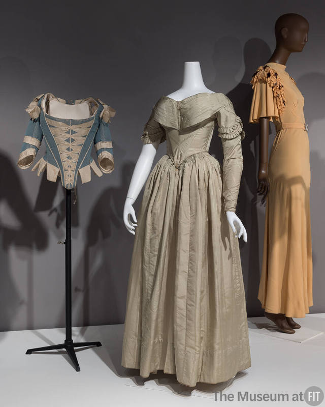 A portion of the Performance & Purpose section, all with removable sleeves. From left to right: corset, c.1770 (P82.1.16); dress, c.1840 (P87.20.48); dress, c.1933 (P88.19.1).