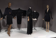 Statement Sleeves exhibition installation view of five mannequins in black garments in the Fund…