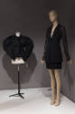 Statement Sleeves exhibition installation view of two mannequins in a black jacket and black su…