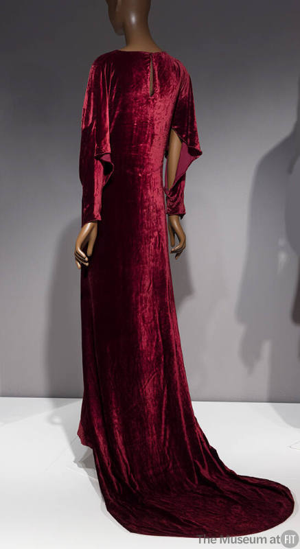 Back view of dark red velvet long sleeve gown with round train