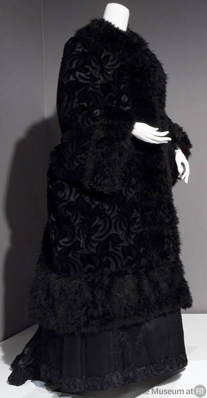 Black broche dolman coat trimmed with black marabou feathers on stand collar, center front and …