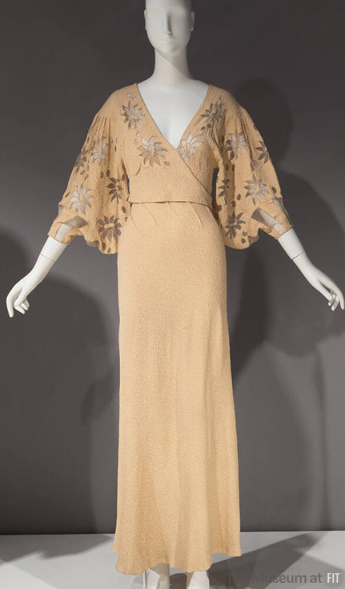 Ivory gown, v neck with floral net inserts on bodice and elbow length sleeves