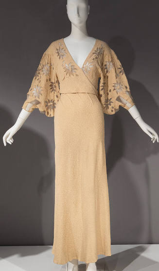 Ivory gown, v neck with floral net inserts on bodice and elbow length sleeves