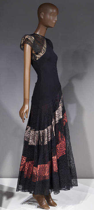 Black gown, asymmetrical drop waist, lace skirt with blue and pink diagonal bands