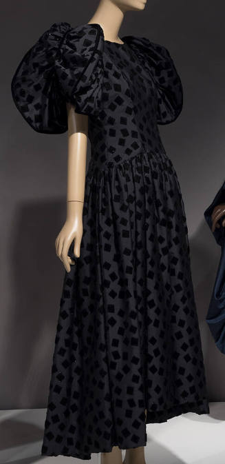 Black taffeta ankle length gown with scattered velvet squares and large puffed sleeves