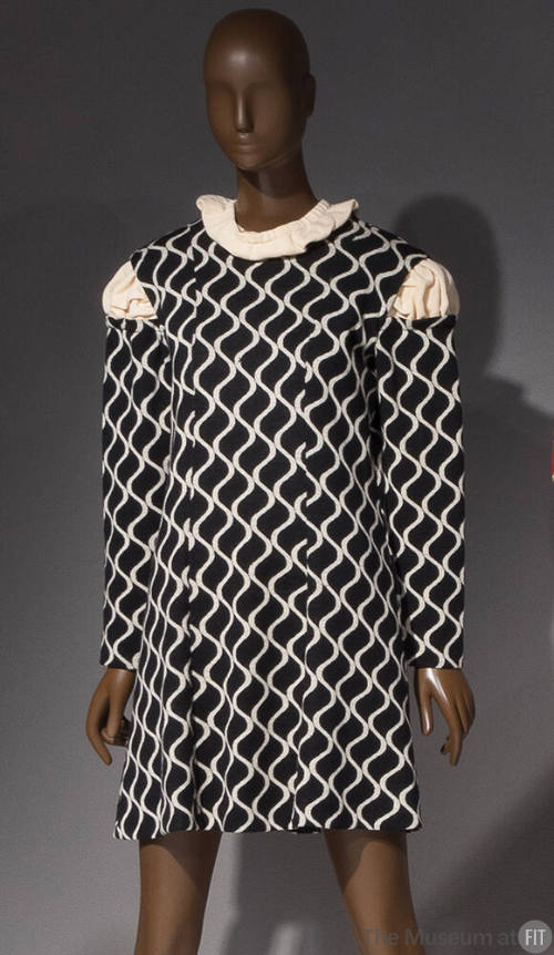 Black shift long sleeved dress with ivory vertical wavy lines, ivory knit inserted at neck and …