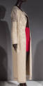Beige floor length coat with gold floral brocade pattern and sheer insets at shoulders, cuffs a…