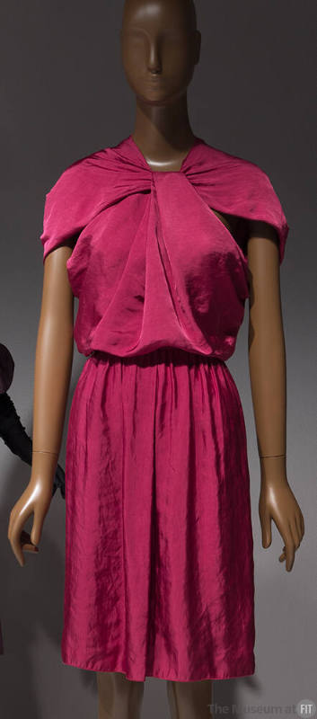 Dark pink knee length dress with capelet sleeves and twist at center neck
