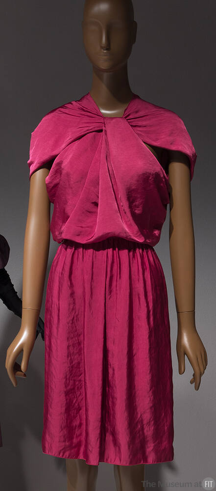 Dark pink knee length dress with capelet sleeves and twist at center neck
