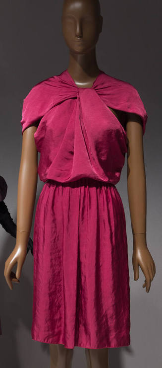 Dark pink knee length dress with capelet sleeves and twist at center neck