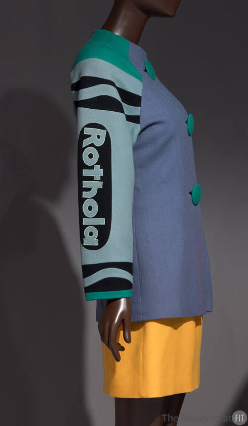 3/4 view of blue long sleeve jacket with green Rothola crayon sleeve, trim and buttons, yellow …