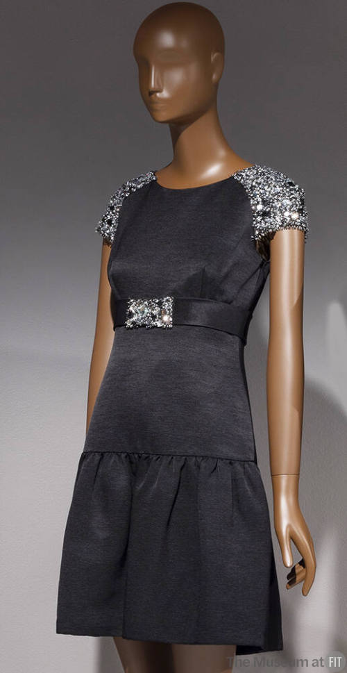 Black above-the-knee dress with rhinestone encrusted cap sleeves, belt with rhinestone buckle, …
