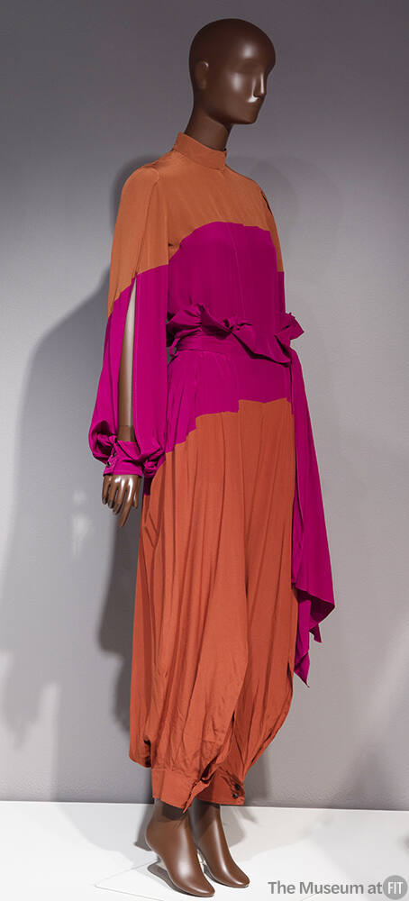 Dark orange blouse with open sleeve and matching loose pants gathered at ankle with pink colorb…