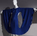 Blue cocktail dress with mannequin arms outstretched to create a semi-circle with long sleeves …