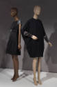 Statement Sleeves exhibition installation view of two mannequins in black dresses with beaded s…