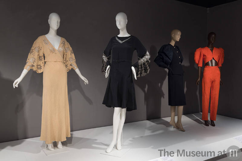 From left to right: pink evening gown, c.1932 (81.159.1); black dress, c.1927 (81.159.2); cocktail suit by Adrian, c.1950 (71.220.1); set by Yves Saint Laurent Rive Gauche, summer 1992 (2022.65.24)