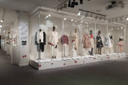 Untying the Bow exhibition installation view of dressed mannequins and accessories in cases on …