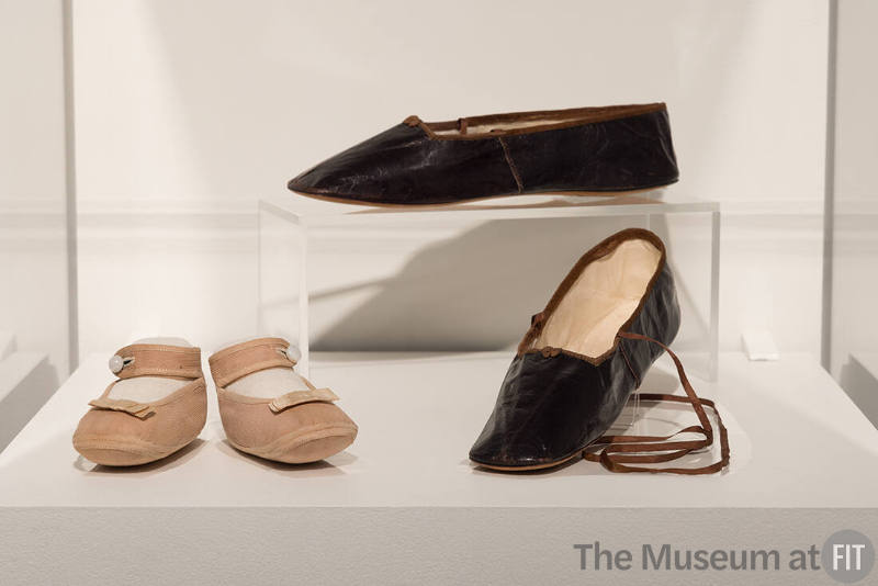 Pink infant's shoes, c.1900 (73.97.33, left) and black shoes, 1835-1850 (P85.35.6, right)