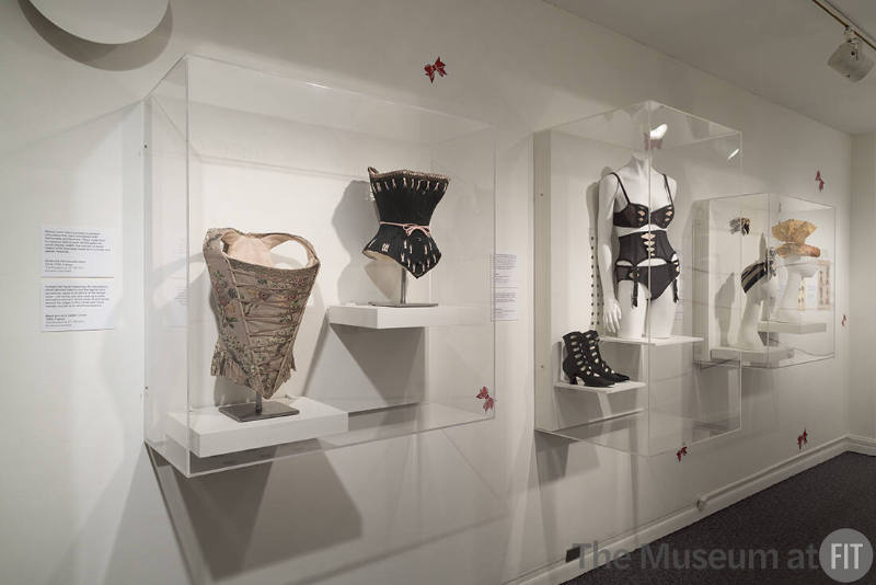 From left to right: Brocade corset, c.1750 (99.79.3); black corset, 1880 (98.29.4); J & J Slater boots, c.1914 (2008.84.16); Chantal Thomass ensemble, Fall 2013 (2014.7.2); Lilly Daché hat, c.1937 (95.103.88), Christian Dior headwear, c.1954 (86.31.11), and Lilly Daché, c.1955 (77.42.1)