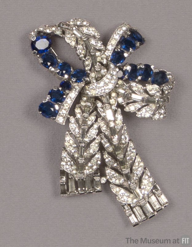 Bow shaped brooch of clear and blue rhinestones