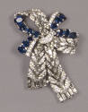 Bow shaped brooch of clear and blue rhinestones