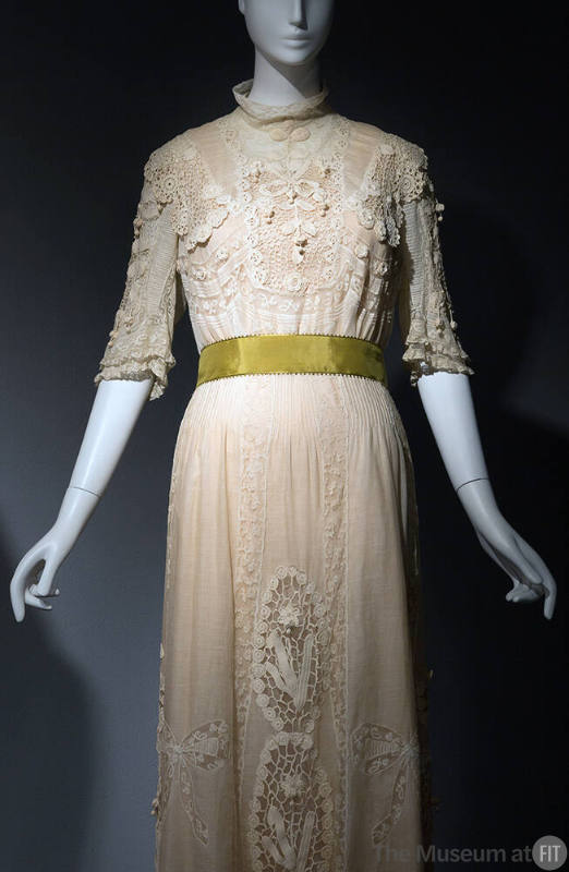 White sheer floor length dress embroidered and inset with lace, short stand collar, elbow lengt…
