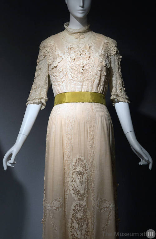 White sheer floor length dress embroidered and inset with lace, short stand collar, elbow lengt…