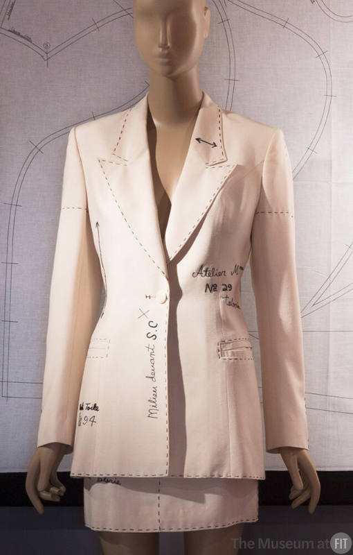 Off white toile suit and mini skirt with trompe-l'oeil lines simulating a muslin pattern marked…