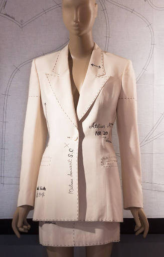 Off white toile suit and mini skirt with trompe-l'oeil lines simulating a muslin pattern marked…
